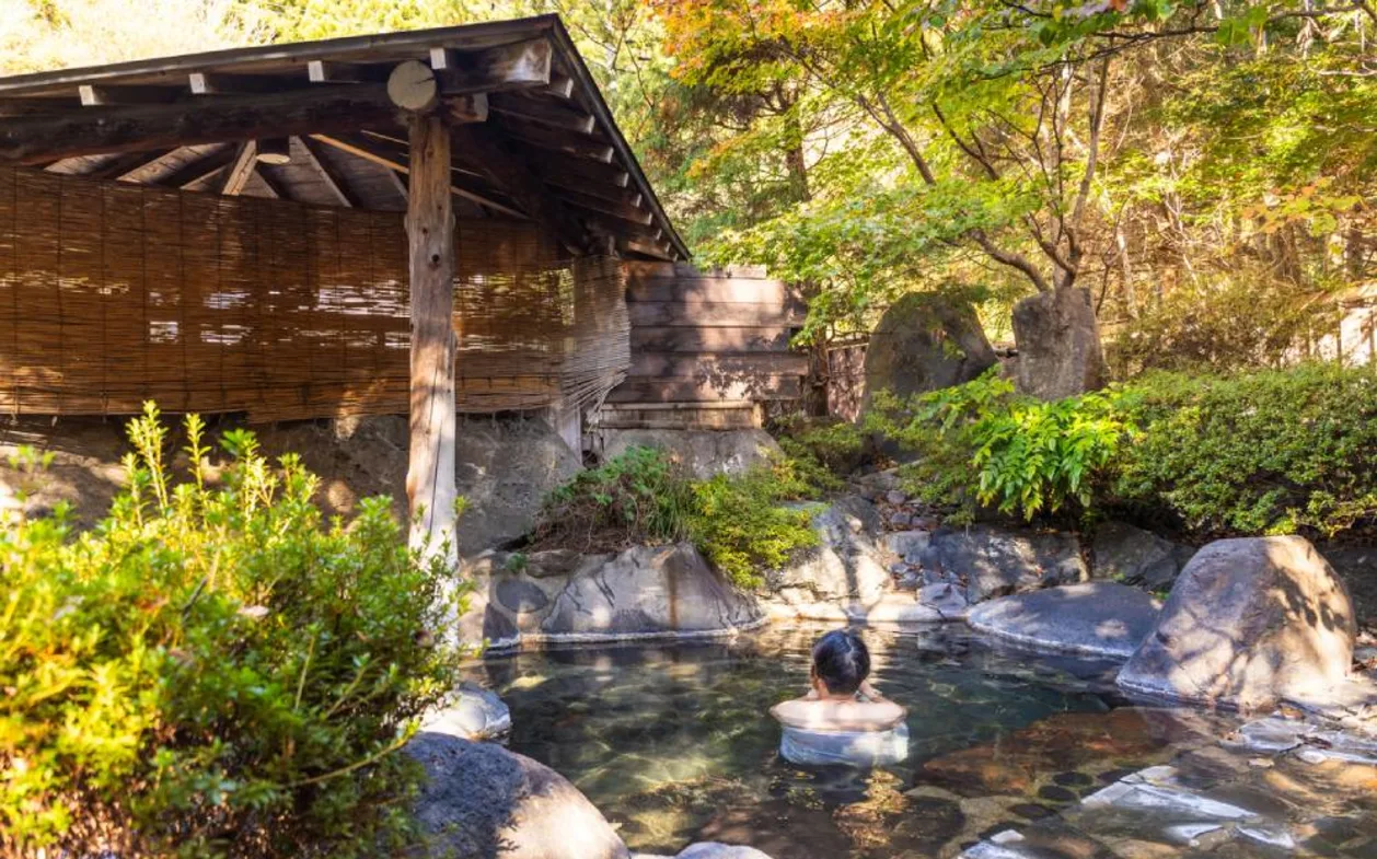 Japanese woman relaxing in outdoor onsen